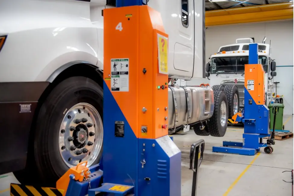 Technicians working safely with mobile column lifts